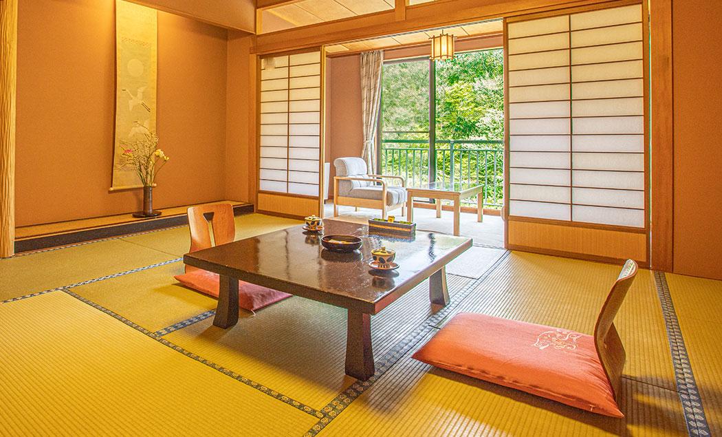Traditional tatami room with low table and shoji screens in Japan ryokan