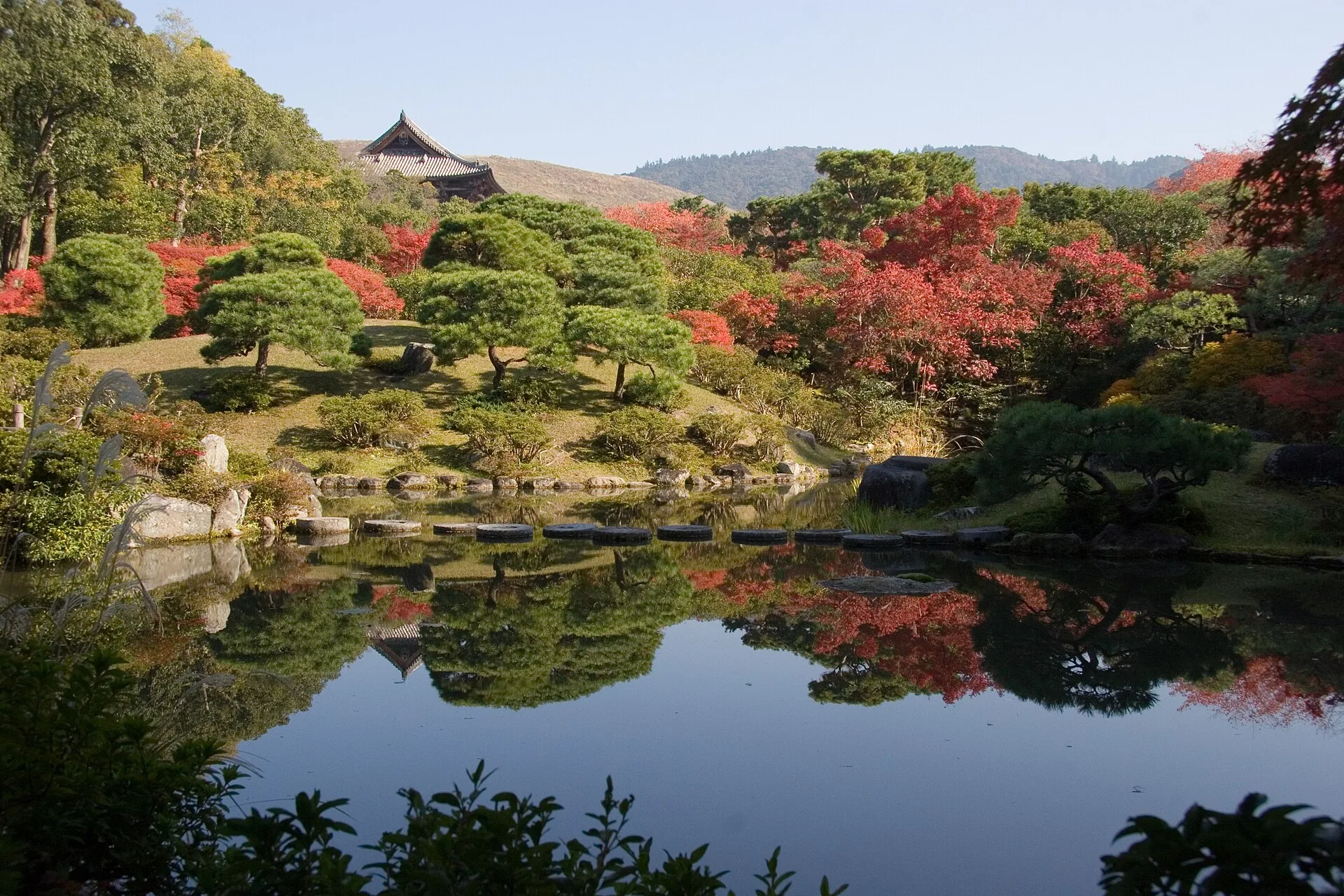 Isuien Garden in Nara with the Todai-ji Nandaimon gate roof in the background